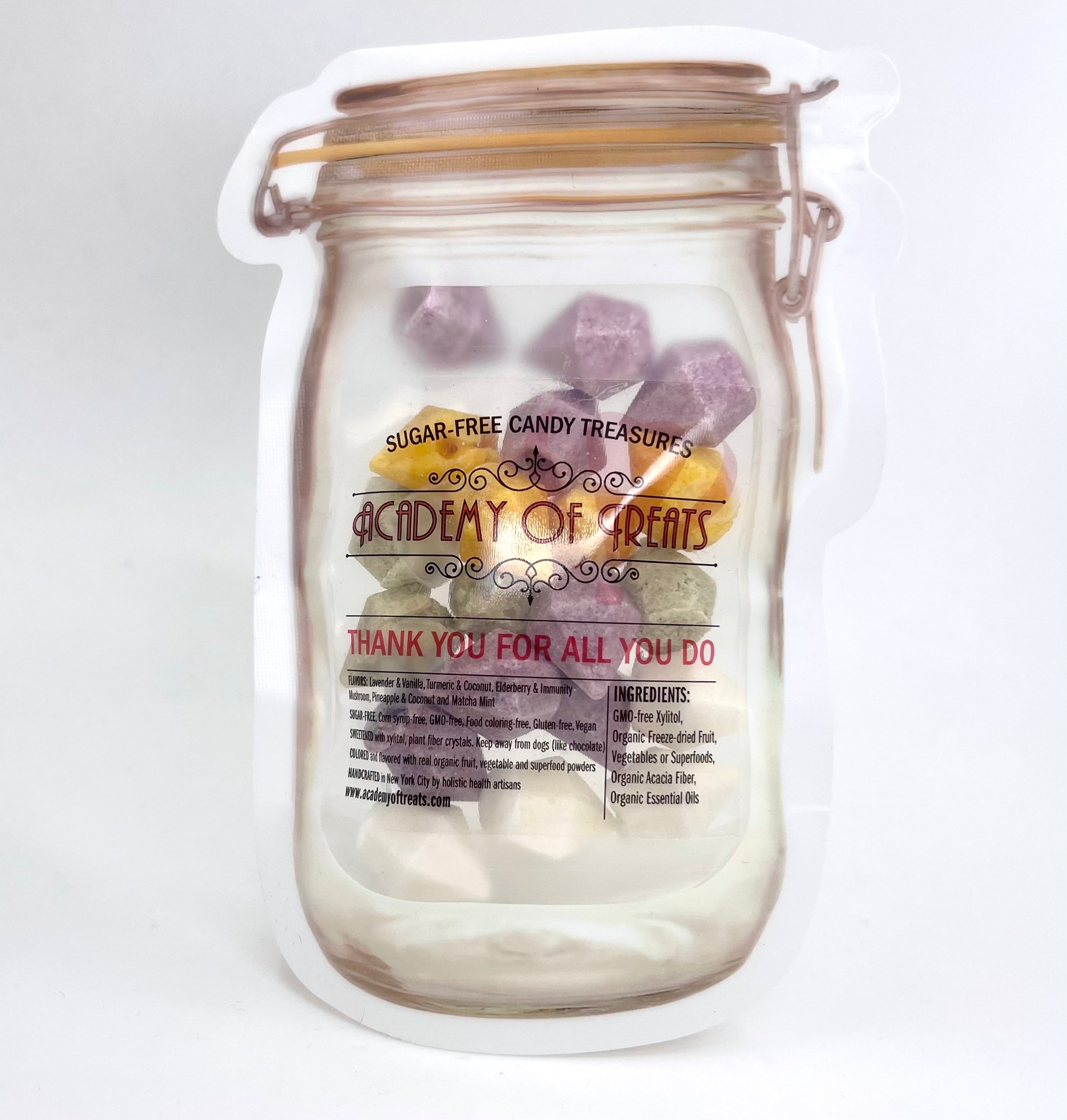 A clear plastic mason jar with a label that reads 'Academy of Treats - Sugar Free Candy Treats', containing various colorful candy pieces. The jar is sealed with a metal lid and has a 'Thank You For All You Do' message on the label.